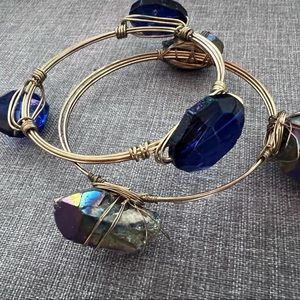 Two Gold Toned Bangels With three Stones on each.